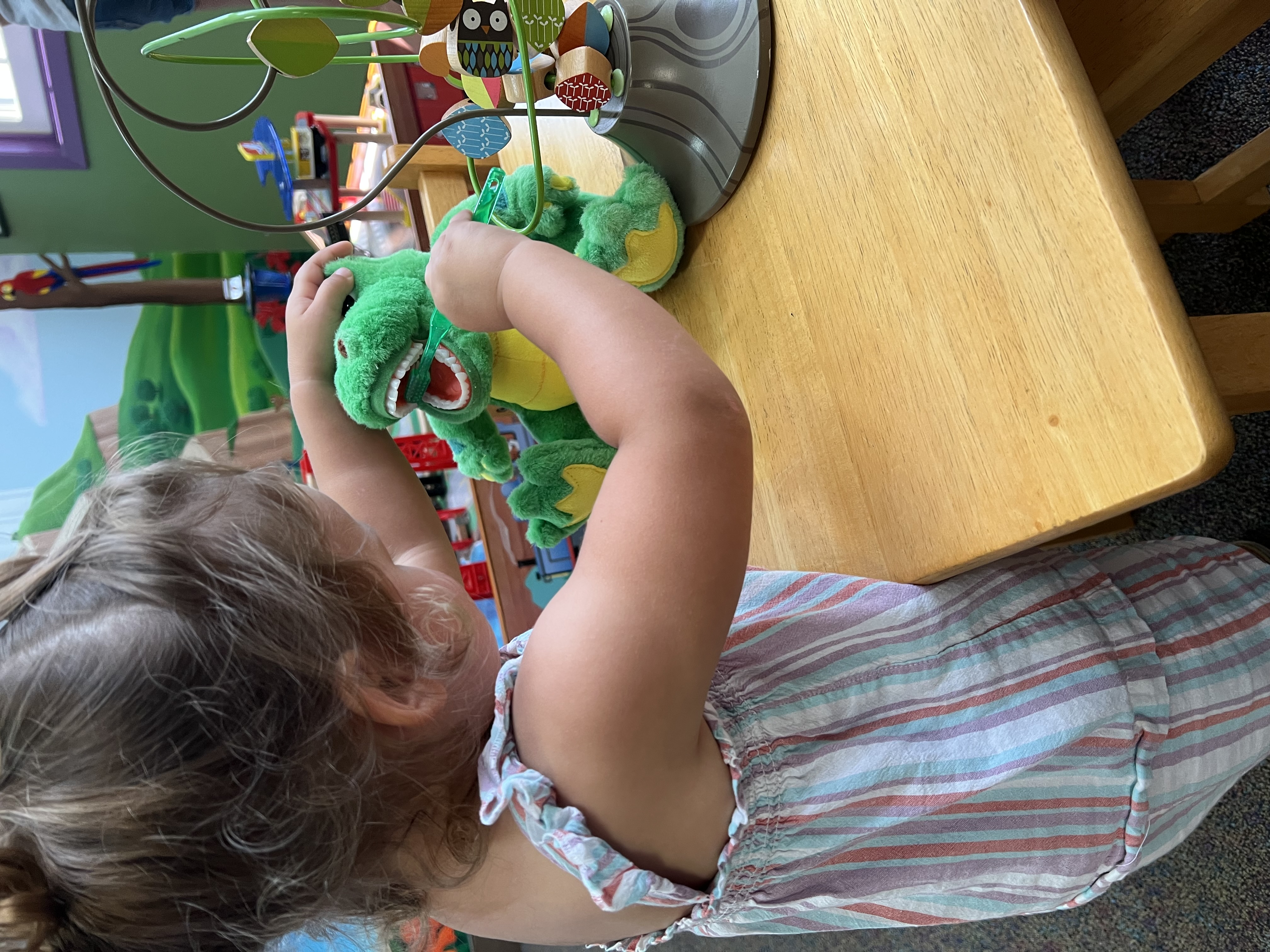 Happy patient playing with a toy dragon in the waiting room
